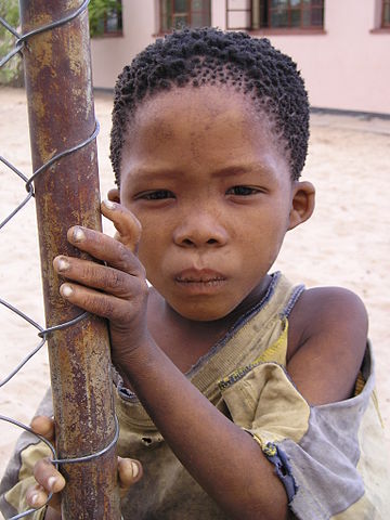 San boy in New Xade, a resettlement camp for people expelled from the Central Kalahari Game Reserve. Photo credit: Public domain via Wikipedia.