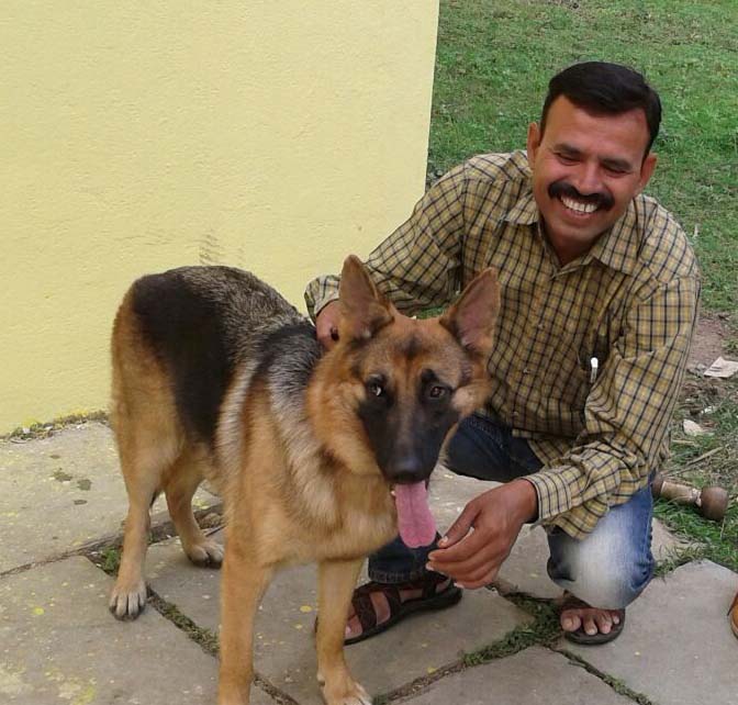 TRAFFIC's sniffer dog Myna with her handler Dinesh Anjana. The team graduated in June and busted a pair of illegal wildlife traders their first day on the job. Photo courtesy of TRAFFIC India.