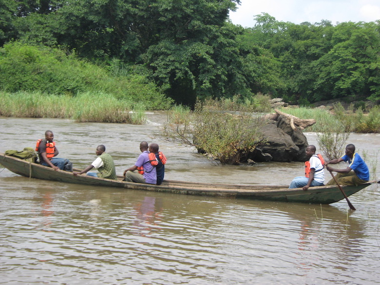 Park rangers cross the River Kam in a traditional dugout canoe while making their patrol rounds. Photo by Lawal Sani Kona. 