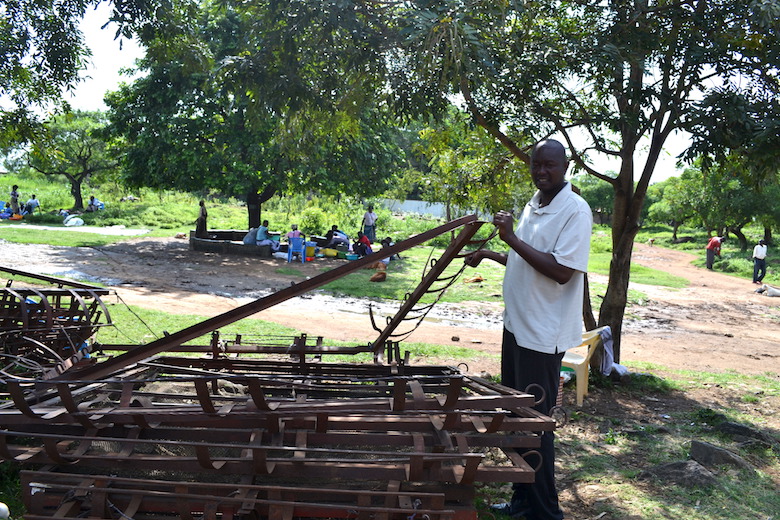 Paul Ochieng Okuta of the Dunga Beach Management Unit, a fishermen’s cooperative, displays some of the materials his group uses to construct floating cages for aquaculture. Photo by Isaiah Esipisu.