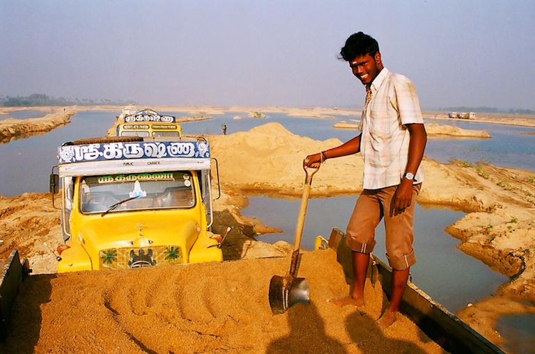 A truck driver loads sand onto his truck in Kanchipuram, Tamil Nadu. Photo by Sibi Arasu.