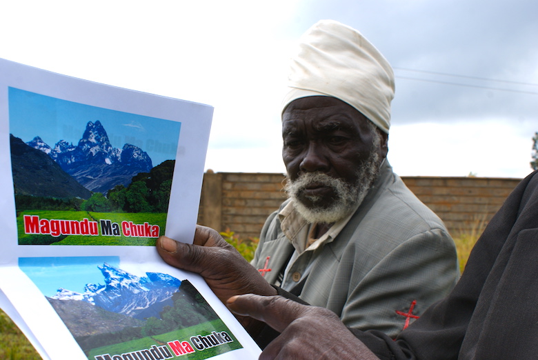 A member of the Atiriri Bururi ma Chuka community group shows a document claiming the right of the community to protect Mt. Kenya forest. Photo by David Njagi.