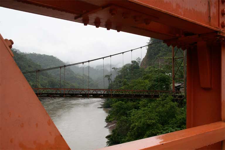 The old Inambari suspension bridge is framed by struts of the new one, looking upstream toward the proposed dam site. The study argues that incorporating ethical analysis into business decisions would help ensure businesses meet their commitments to sustainability, as well as promoting better behavior. Photo © Barbara Fraser