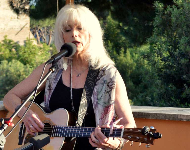Emmylou Harris performs for Jesuit Refugee Service (JRS) officials at the residence of David Lane, US Ambassador to UN Agencies during her refugee fact-finding trip to Rome. Photo by Justin Catanoso