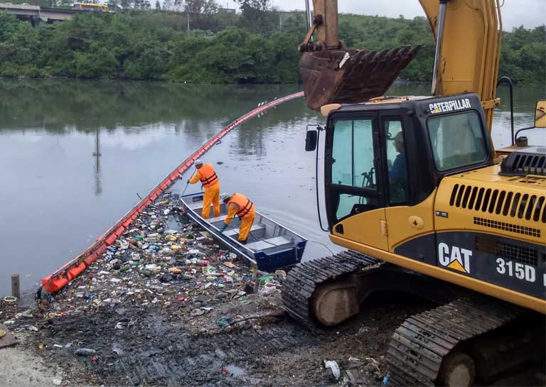 Workers collect trash from a Rio river to keep it out of Guanabara Bay where Olympics aquatic events will occur. Photo by Rio de Janeiro Environmental State Secretariat
