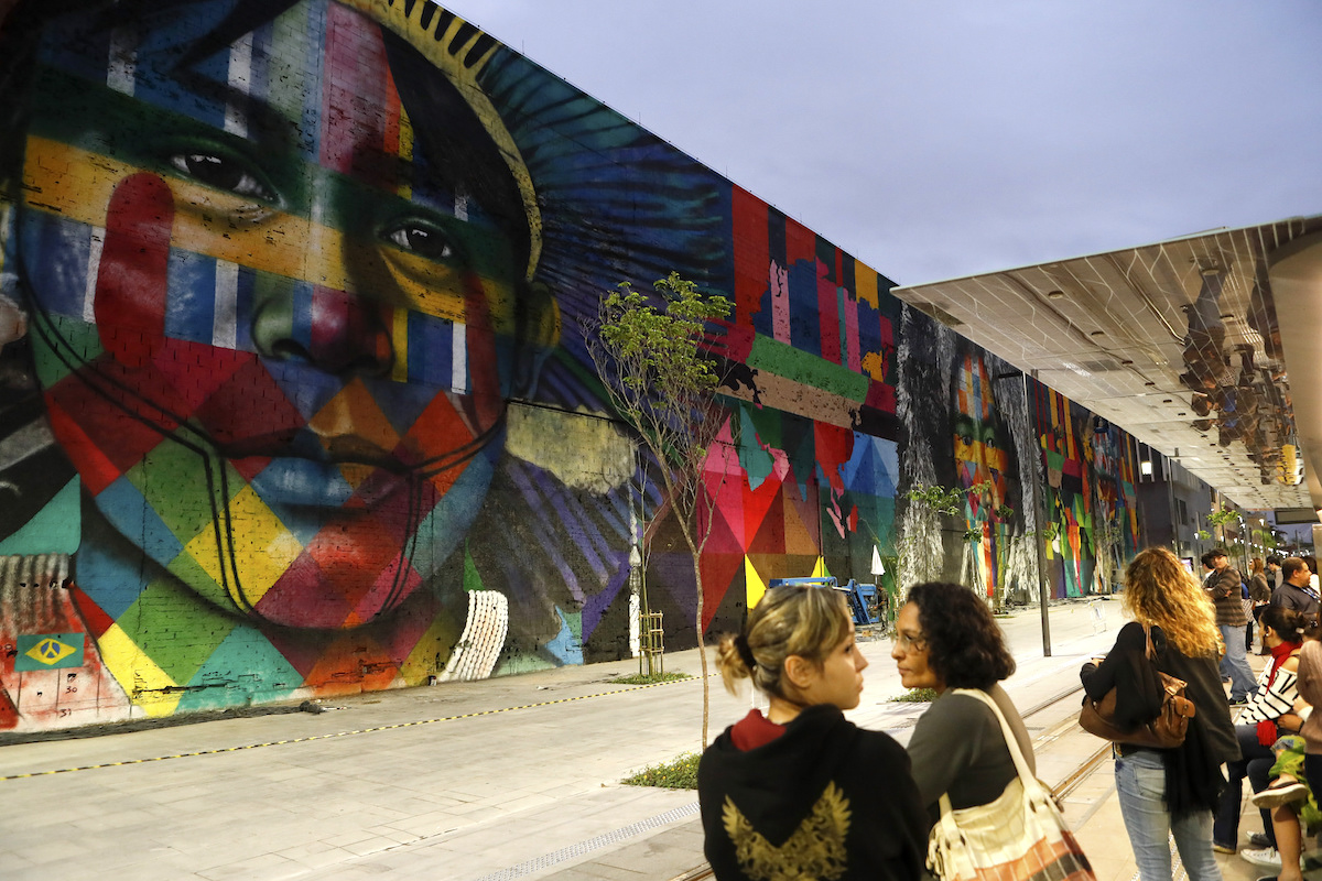 Etnias, a 620-foot long mural in Rio de Janiero, Brazil, representing indigenous people from five continents by Brazilian artist Eduardo Kobra. The mural was commissioned for the Olympics. Photo by Agência Brasil Fotografias.