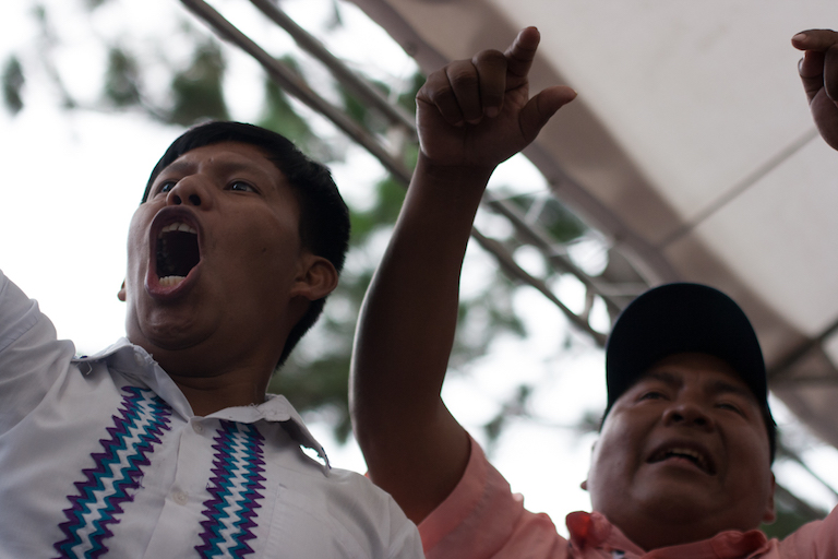 Ricardo Miranda (left), a member of the M10 movement representing Ngäbe communities affected by the Barro Blanco dam, and Toribio Garcia, president of the Ngäbe Regional Congress, protest the agreement. Photo by Camilo Mejia Giraldo