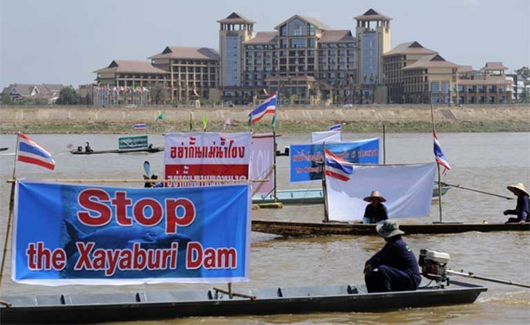 Villagers in Thailand protest the construction of the Xayaburi Dam on the Mekong River during the Asia Europe Summit in Vientiane, Laos in 2012. Very often protests signs used by environmental groups against large infrastructure projects feature both a country’s native language and also English, so that if the demonstration gains coverage by the international press the message will get easily communicated to the English-speaking world. Photo by Pianpron Deetes / International Rivers CC-BY-NC-SA 2.0 (Flickr)