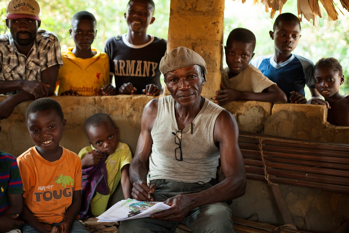 Wally, drawing to educate and raise awareness about environmental conservation among his community neighboring the Salonga National Park, Monkoto, Tshuapa, DRC, October 2016. Photo by Leonora Baumann for Mongabay.