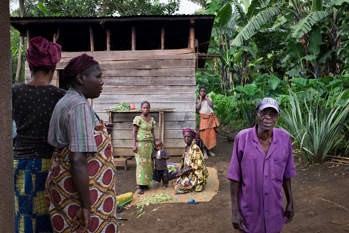 Retired charcoal burner Marcel Muhima with his relatives in front of his family home in Bushenge, North Kivu, DRC, November 2016. Photo by Leonora Baumann for Mongabay.