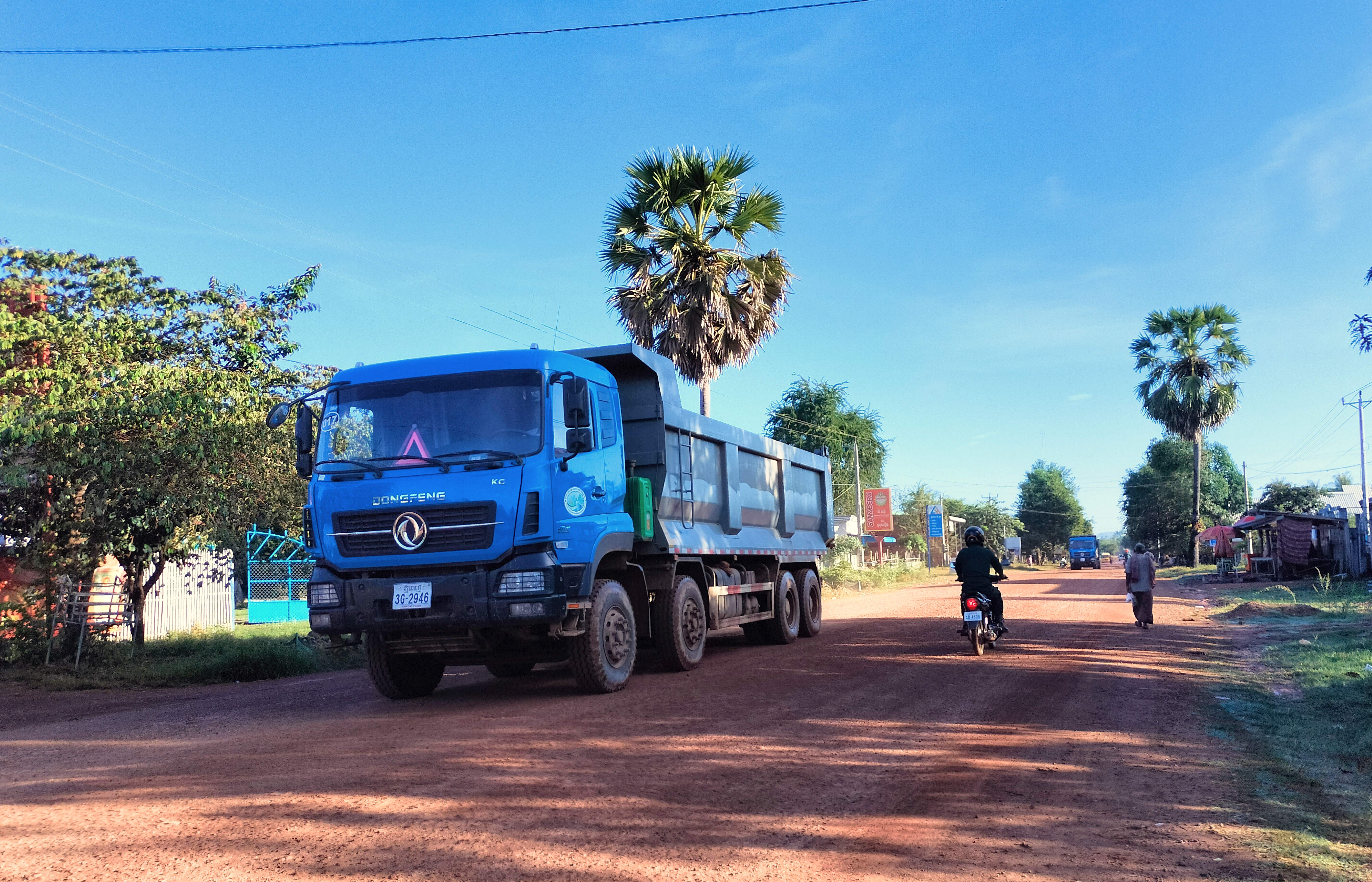 Trucks bearing Global Green's logo stuck to the side of the door have destroyed roads across Preah Vihear province as they carry iron ore from protected areas to Try Pheap's port in Kampong Chhnang province. Image by Gerald Flynn / Mongabay.